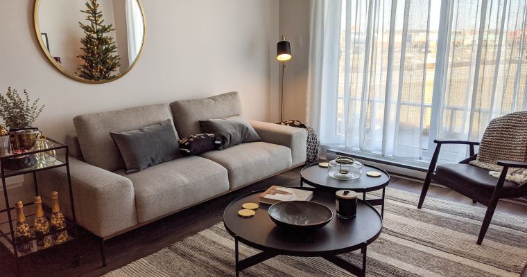 Living room with couch, coffee table, and armchair.