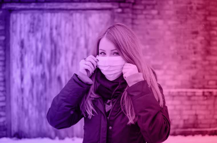 Woman wearing a face mask outdoors.