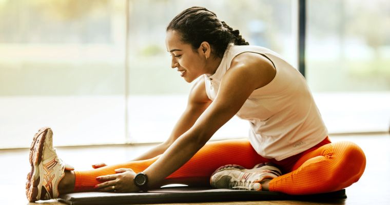 Woman stretching in workout clothes.