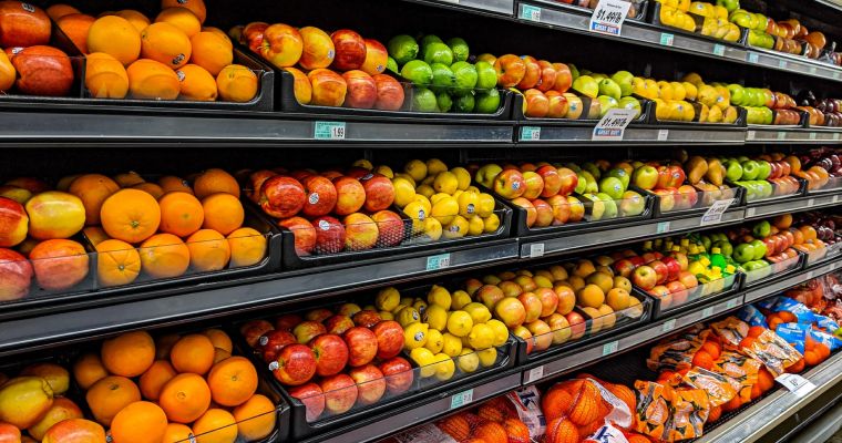 Produce shelves stocked with fruit.