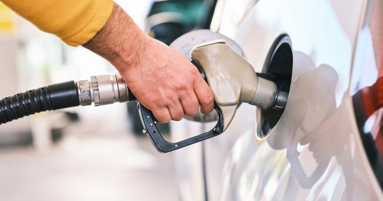 Person filling car with gasoline.