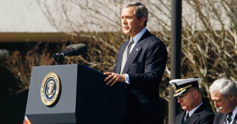 George W. Bush speaking at a podium.