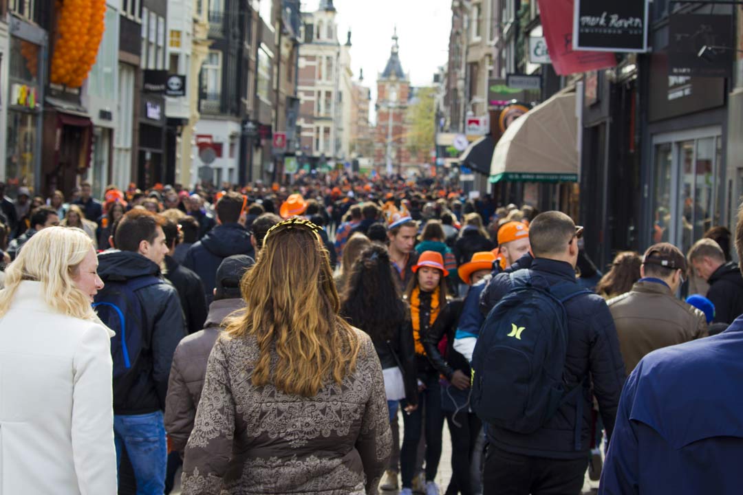 Crowded street scene with people walking.