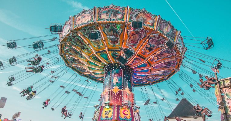 Colorful carnival ride with people swinging