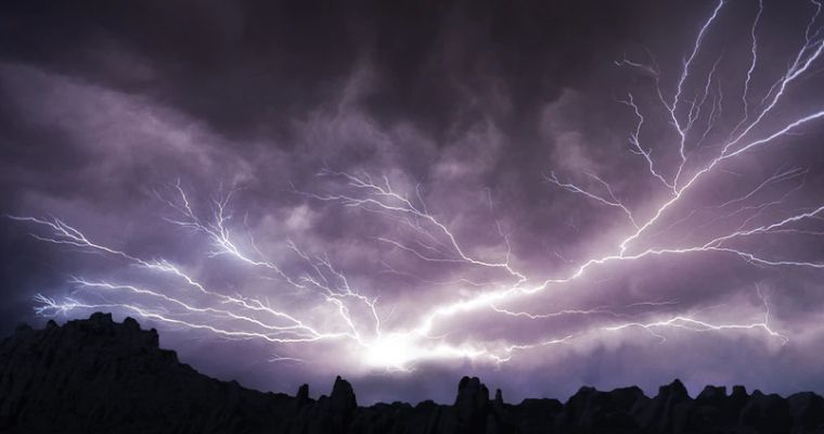 Lightning strikes across a stormy sky.