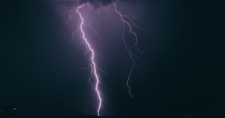 Lightning strike in a dark sky.