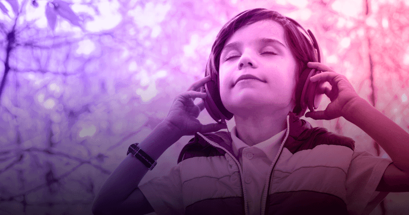 Young person listening to music outdoors.