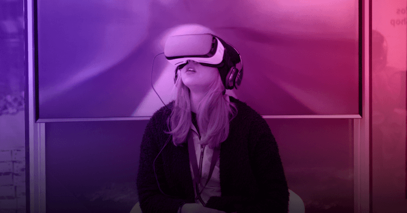 Woman wearing VR headset, looking up.